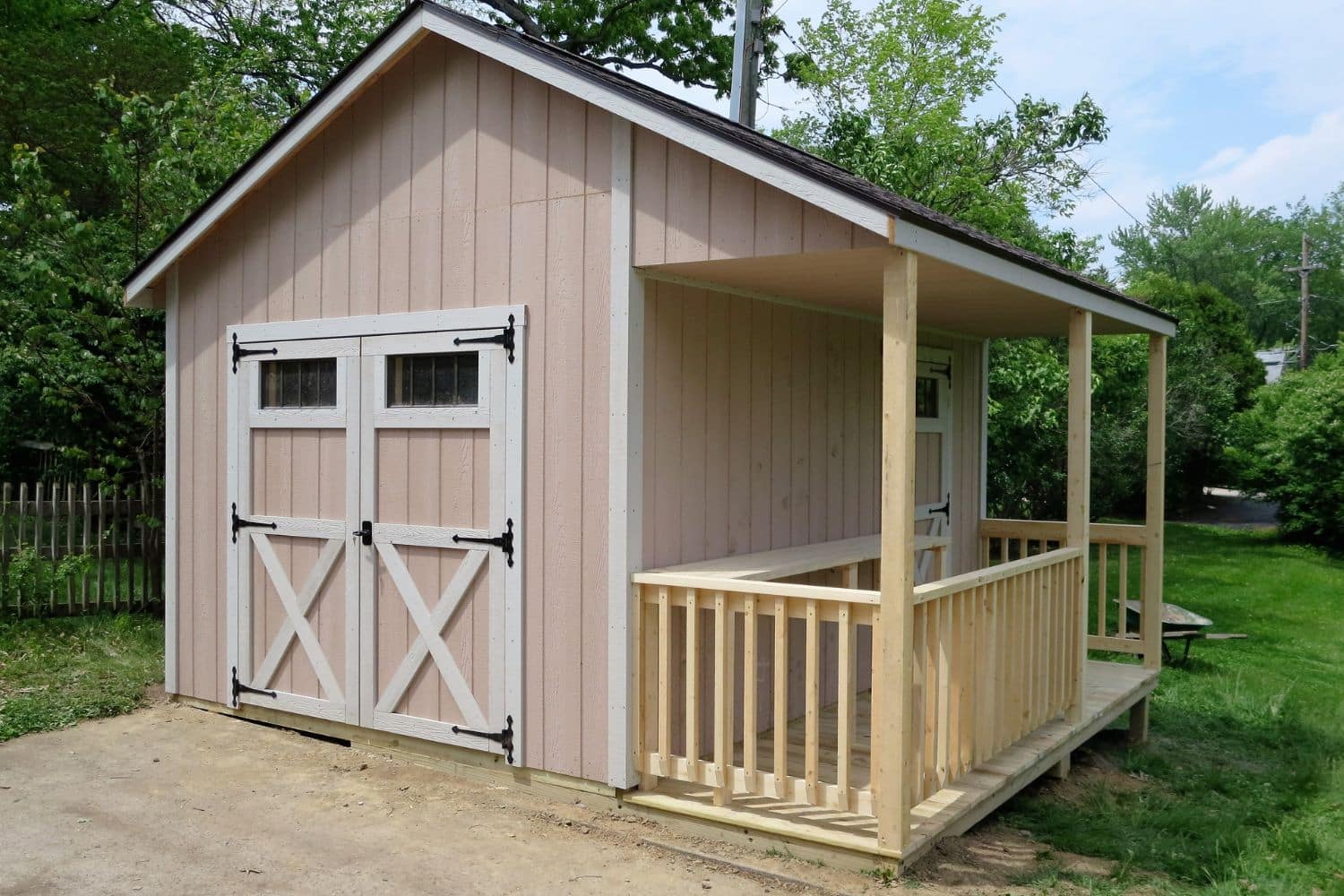 One of our peach and white Cabin sheds for sale in Worthington OH - Peach siding with white trimmed double and single doors
