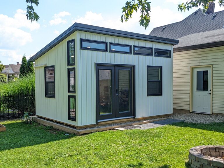 Green Modern Studio shed with large front windows and modern design