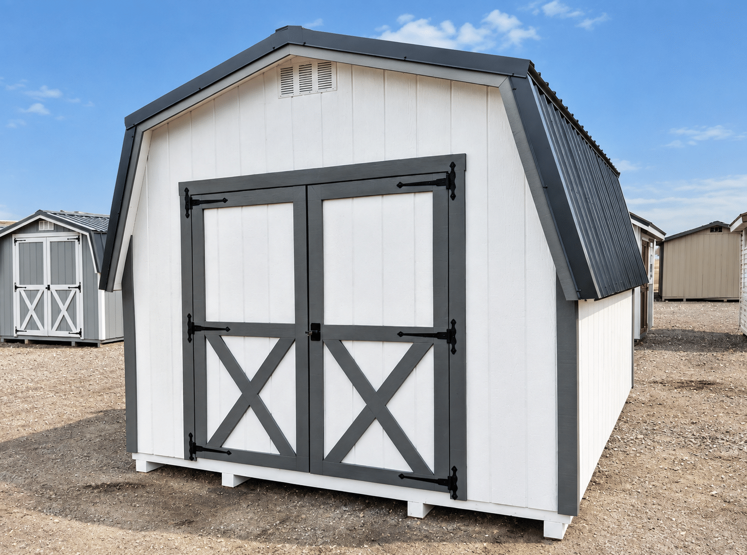 White barn shed with black trim and double doors, one of the barn sheds for sale in Ohio, offering extra storage space and headroom
