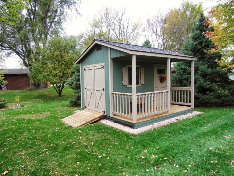Green cabin shed with covered front porch, one of the cabin sheds for sale in Ohio