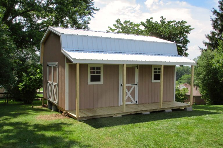 Tan shed with metal roof and covered front porch, one of the sheds with porches