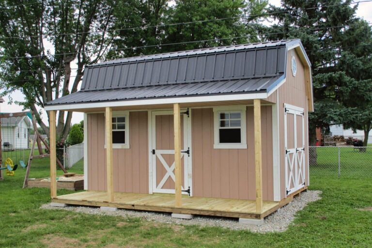 Tan shed with front porch and barn doors, one of the sheds with porches for storage