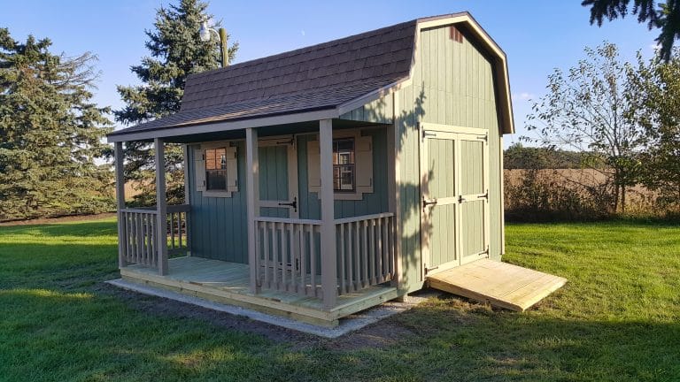 Green shed with covered porch and ramp, one of the stylish sheds with porches