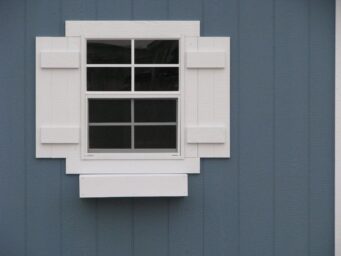 storage buildings window with shutters and flower box