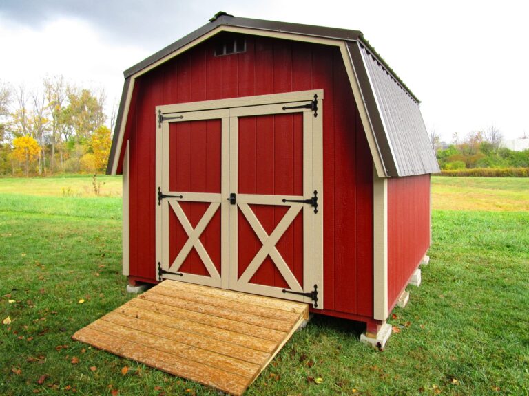 RedClassic shed with beige-trimmed double doors.