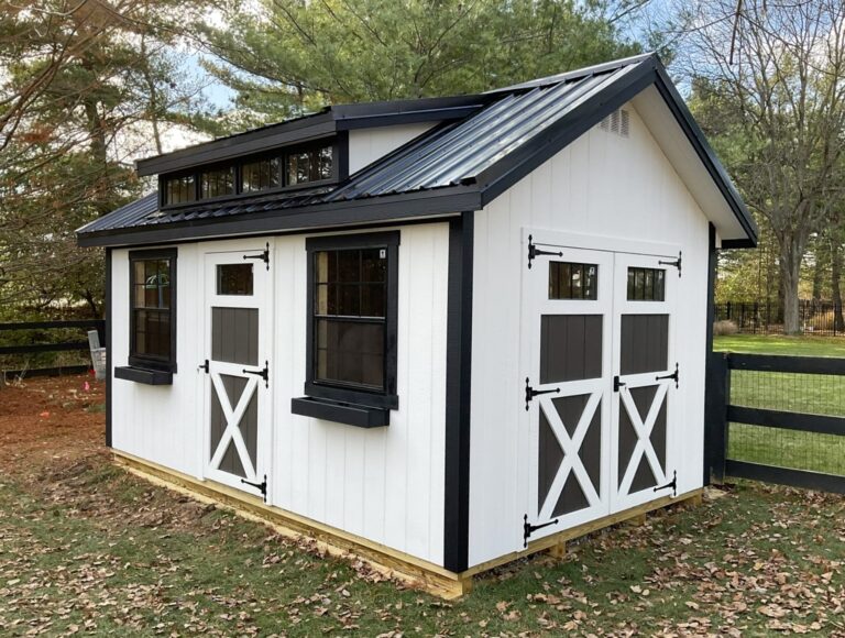White cottage shed for sale in Ohio with black trim and metal roof